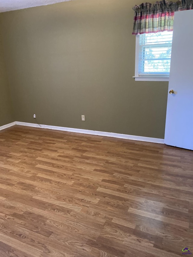 spare room featuring hardwood / wood-style floors