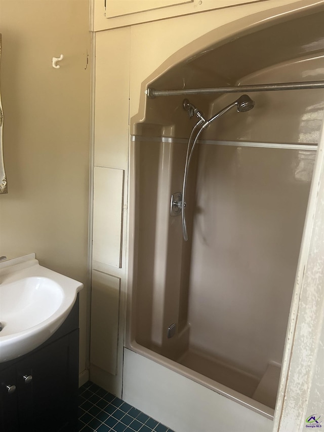 bathroom with vanity, tub / shower combination, and tile patterned flooring