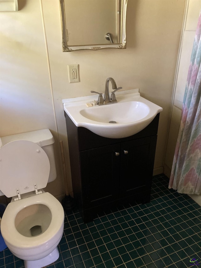 bathroom with vanity, toilet, and tile patterned flooring