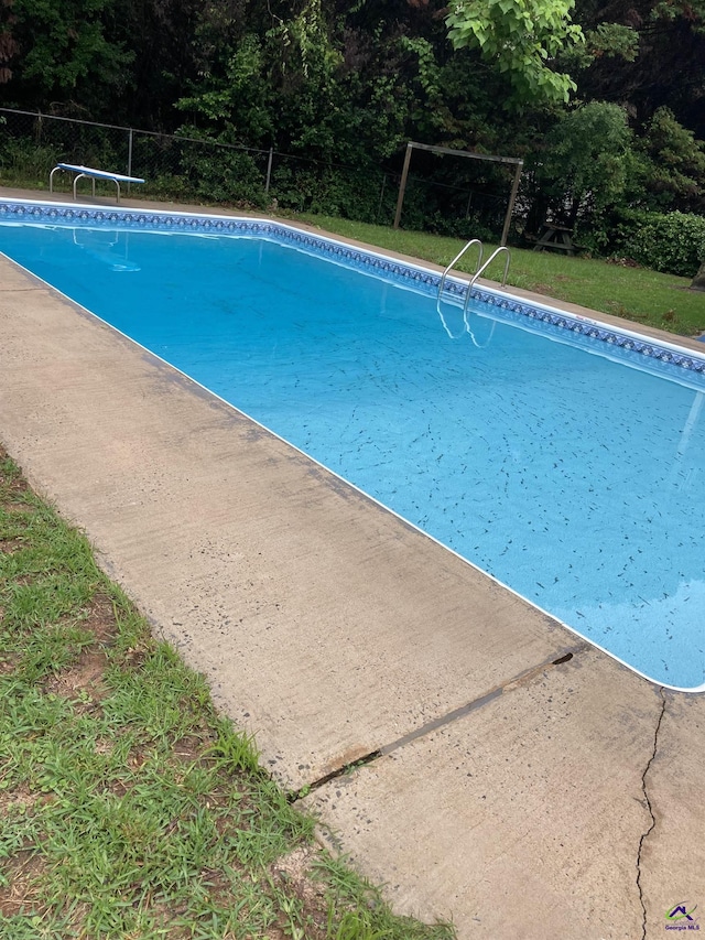 view of pool featuring a diving board