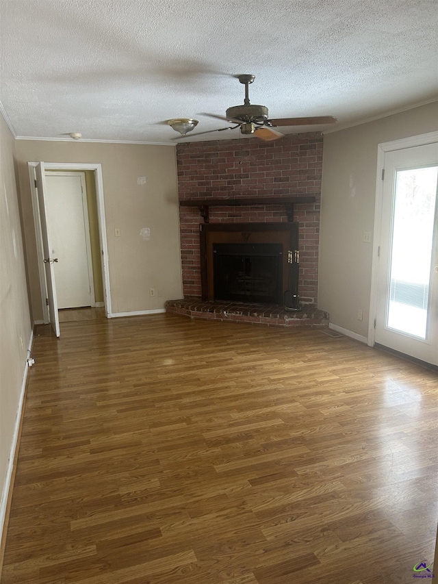 unfurnished living room featuring dark hardwood / wood-style floors, a textured ceiling, and a fireplace