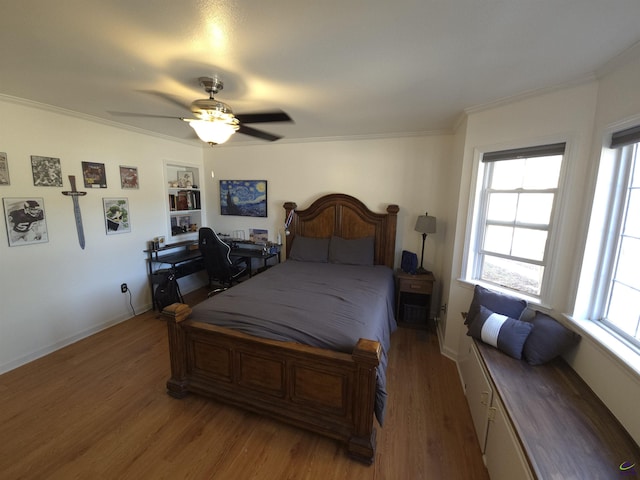 bedroom featuring baseboards, light wood-style flooring, a ceiling fan, and crown molding