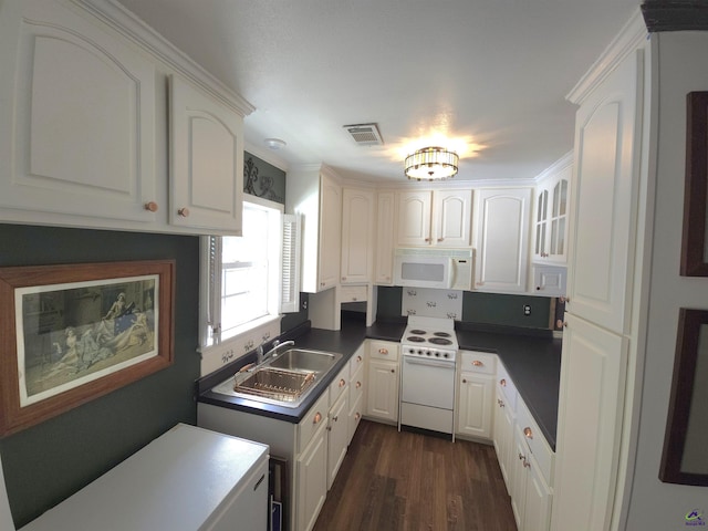 kitchen featuring dark wood-style floors, visible vents, white cabinetry, a sink, and white appliances