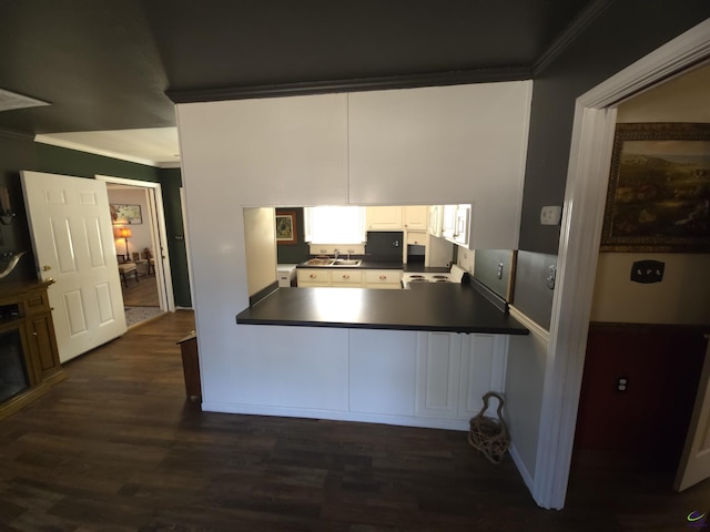 kitchen with dark hardwood / wood-style floors, white cabinetry, sink, kitchen peninsula, and crown molding