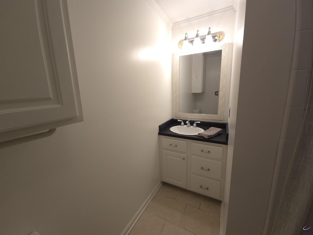 bathroom with tile patterned flooring, crown molding, vanity, and baseboards