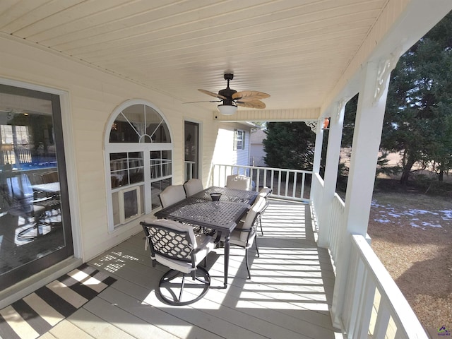 wooden deck featuring ceiling fan and outdoor dining area