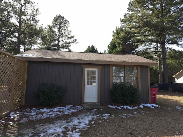 view of outbuilding featuring an outdoor structure and fence