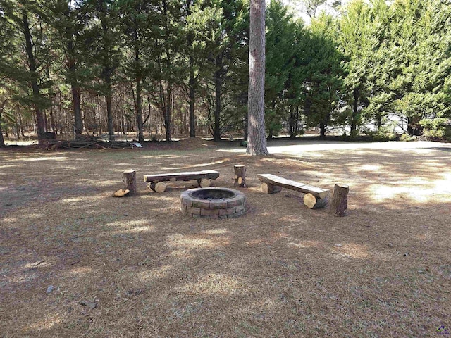 view of community featuring an outdoor fire pit