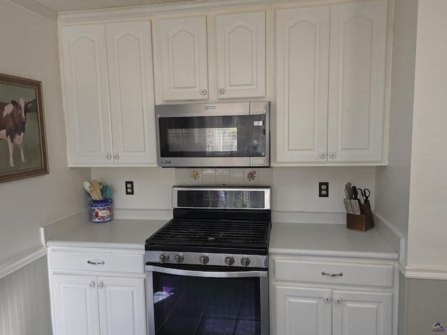 kitchen featuring stainless steel appliances and white cabinetry