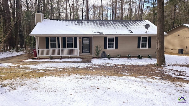 view of front facade with cooling unit and a porch