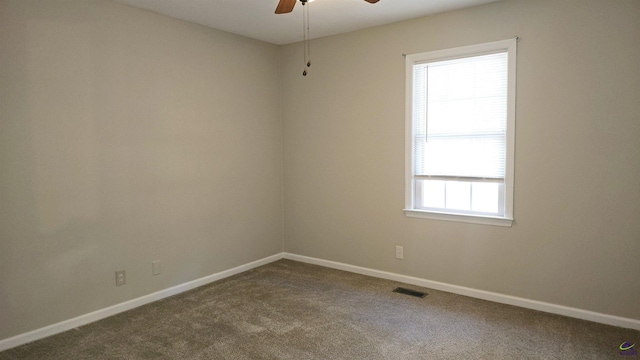 carpeted empty room featuring plenty of natural light and ceiling fan