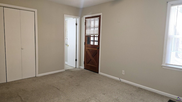 unfurnished bedroom with light colored carpet