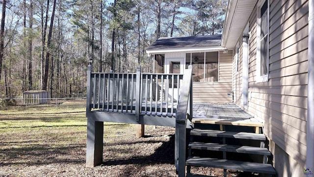 deck featuring a lawn and a sunroom