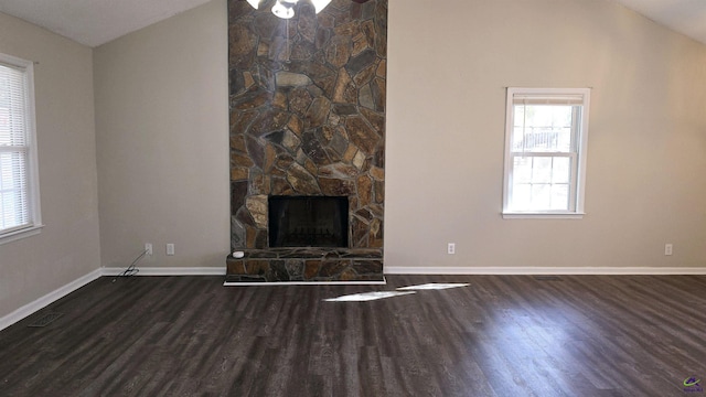 unfurnished living room with lofted ceiling, dark wood-type flooring, and a fireplace