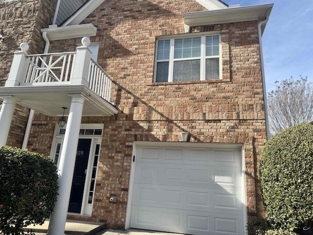 doorway to property featuring a balcony and a garage