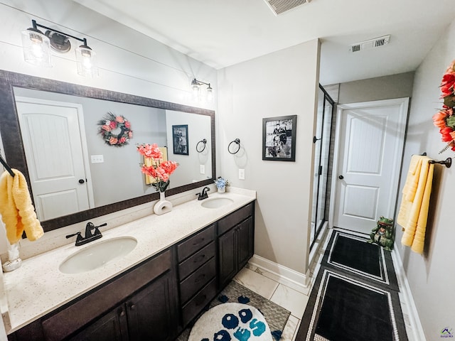 bathroom with vanity, tile patterned flooring, and a shower with door