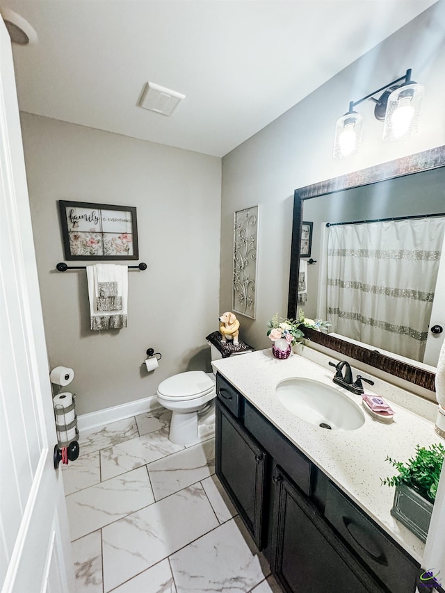 bathroom featuring vanity and toilet