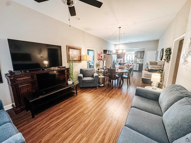 living room featuring wood-type flooring and ceiling fan