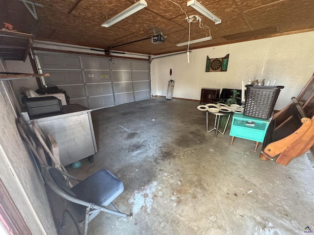 garage featuring a garage door opener and washer / dryer