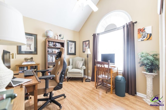 home office featuring ceiling fan, high vaulted ceiling, and light wood-type flooring