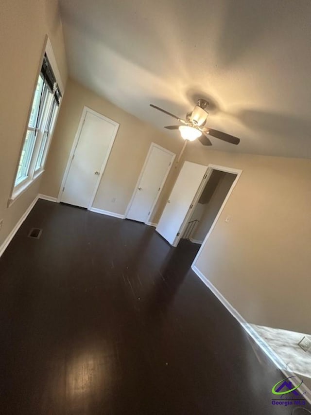 additional living space with dark wood-type flooring and ceiling fan