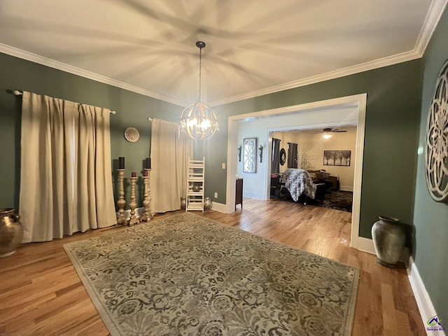 dining space with light wood-type flooring, baseboards, and crown molding