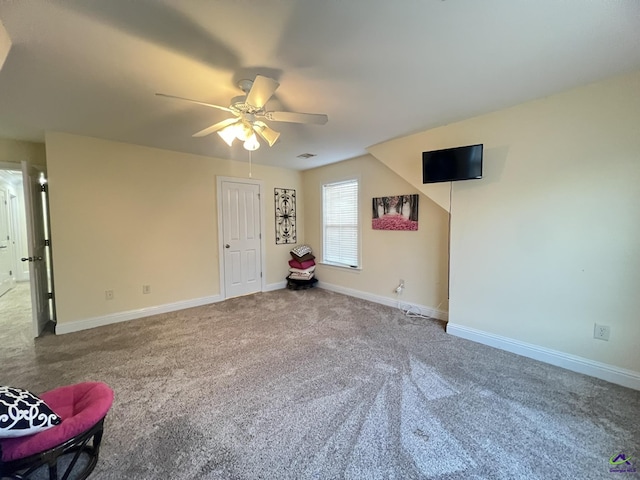 interior space featuring visible vents, carpet flooring, a ceiling fan, and baseboards