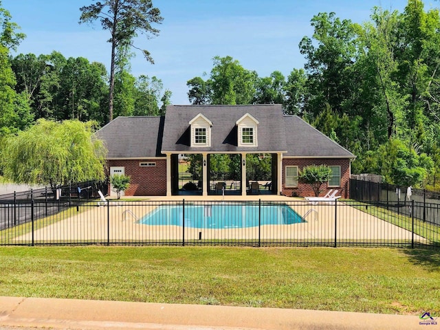 view of pool featuring a yard, a patio, fence, and a fenced in pool