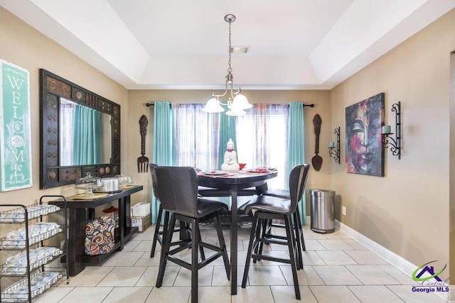 306 Lovorn Cir, Warner Robins, GA 31088 - dining area featuring a chandelier, a raised ceiling, baseboards, and light tile patterned flooring