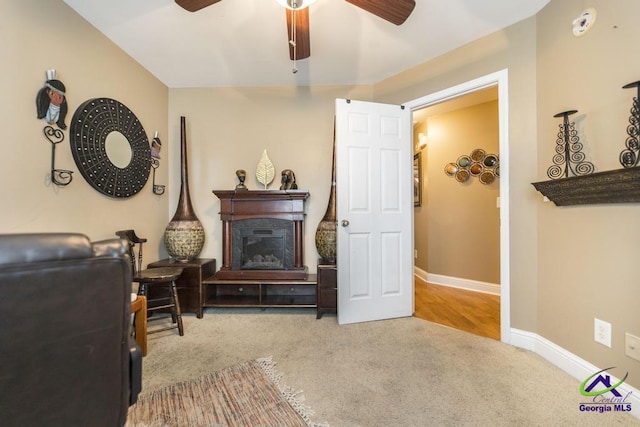 306 Lovorn Cir, Warner Robins, GA 31088 - living area featuring carpet floors, ceiling fan, baseboards, and a glass covered fireplace
