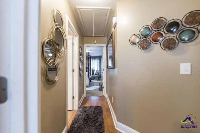 306 Lovorn Cir, Warner Robins, GA 31088 - hall with attic access, wood finished floors, and baseboards