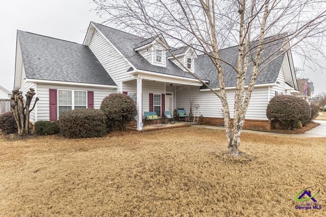 306 Lovorn Cir, Warner Robins, GA 31088 - cape cod house featuring a shingled roof and a front lawn