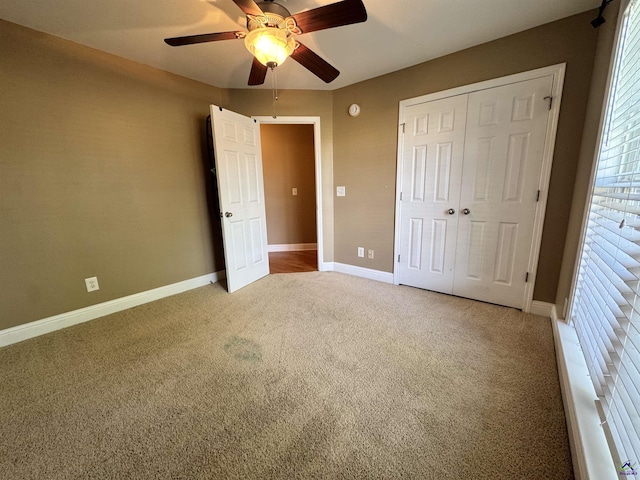 306 Lovorn Cir, Warner Robins, GA 31088 - unfurnished bedroom with light colored carpet, a closet, baseboards, and a ceiling fan