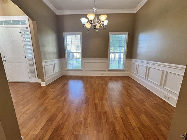 306 Lovorn Cir, Warner Robins, GA 31088 - unfurnished dining area with plenty of natural light, a chandelier, arched walkways, ornamental molding, and wood finished floors