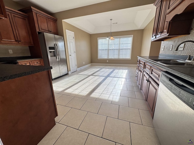 306 Lovorn Cir, Warner Robins, GA 31088 - kitchen featuring appliances with stainless steel finishes, dark countertops, a sink, tasteful backsplash, and light tile patterned floors