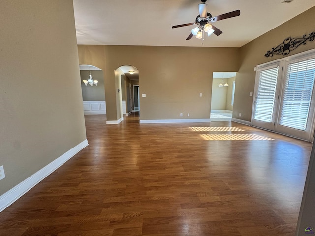 306 Lovorn Cir, Warner Robins, GA 31088 - unfurnished room featuring arched walkways, a ceiling fan, wood finished floors, and baseboards