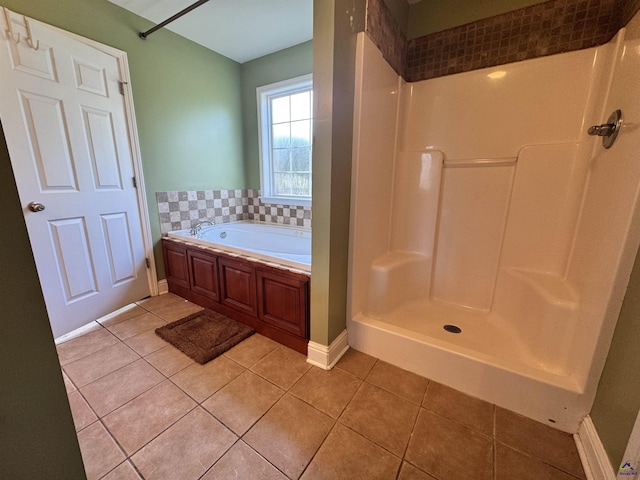 306 Lovorn Cir, Warner Robins, GA 31088 - bathroom with tile patterned floors, a garden tub, a shower, and baseboards
