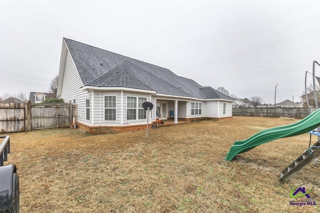 306 Lovorn Cir, Warner Robins, GA 31088 - rear view of house with a shingled roof and a playground