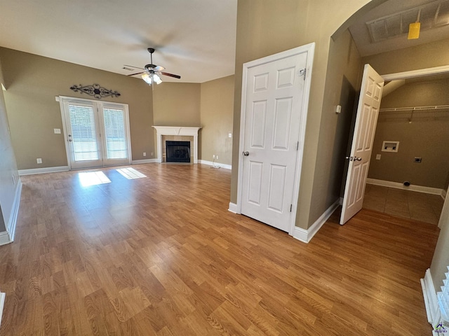 306 Lovorn Cir, Warner Robins, GA 31088 - unfurnished living room featuring ceiling fan, light wood-style floors, and baseboards