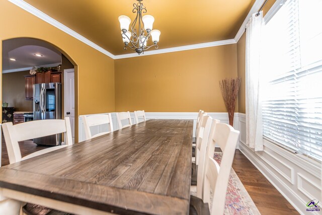 105 Reflection Dr, Bonaire, GA 31005 - dining room featuring dark wood-type flooring, ornamental molding, and a chandelier