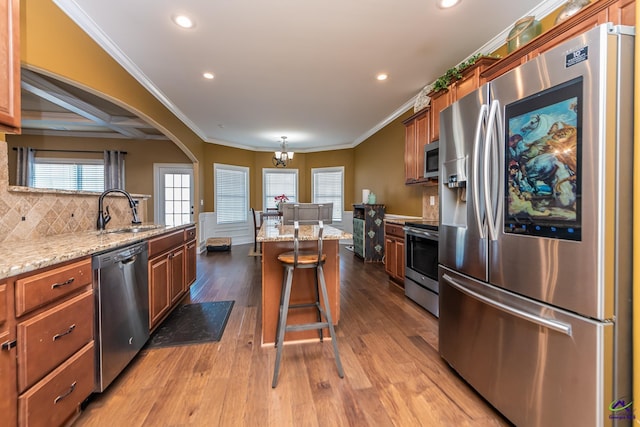105 Reflection Dr, Bonaire, GA 31005 - kitchen with a kitchen bar, sink, a center island, stainless steel appliances, and light hardwood / wood-style floors