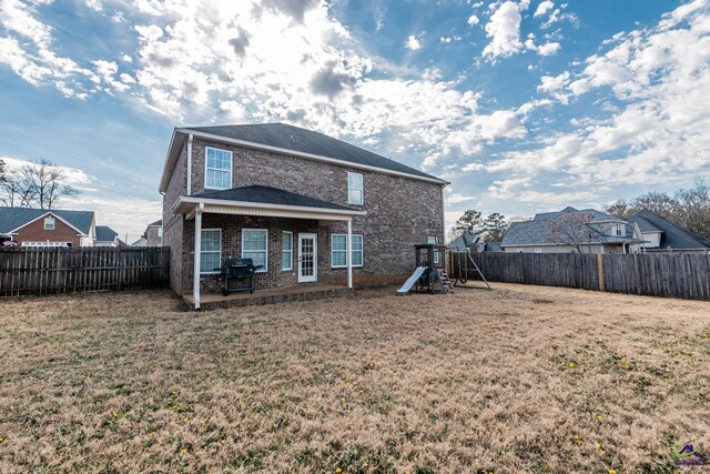 105 Reflection Dr, Bonaire, GA 31005 - rear view of house featuring a playground and a lawn