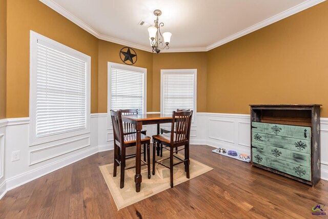 105 Reflection Dr, Bonaire, GA 31005 - dining space featuring an inviting chandelier, crown molding, and dark hardwood / wood-style flooring