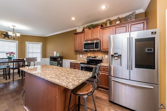 105 Reflection Dr, Bonaire, GA 31005 - kitchen featuring crown molding, stainless steel appliances, a kitchen island, and a notable chandelier