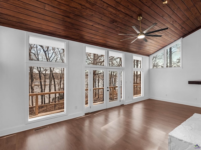 unfurnished sunroom featuring plenty of natural light, wooden ceiling, french doors, and ceiling fan