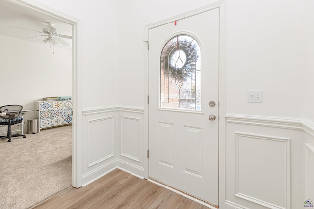 entrance foyer with light colored carpet and ceiling fan