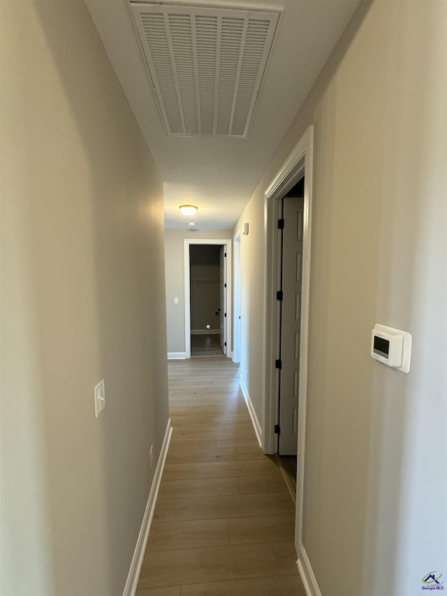 hallway with light hardwood / wood-style flooring