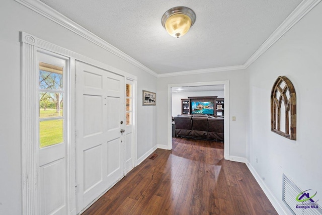 foyer featuring ornamental molding, dark hardwood / wood-style floors, and a textured ceiling