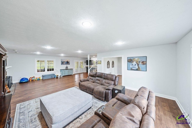 living room with hardwood / wood-style floors and a textured ceiling