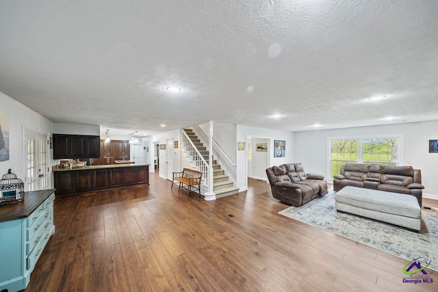 living room with dark hardwood / wood-style flooring and a textured ceiling